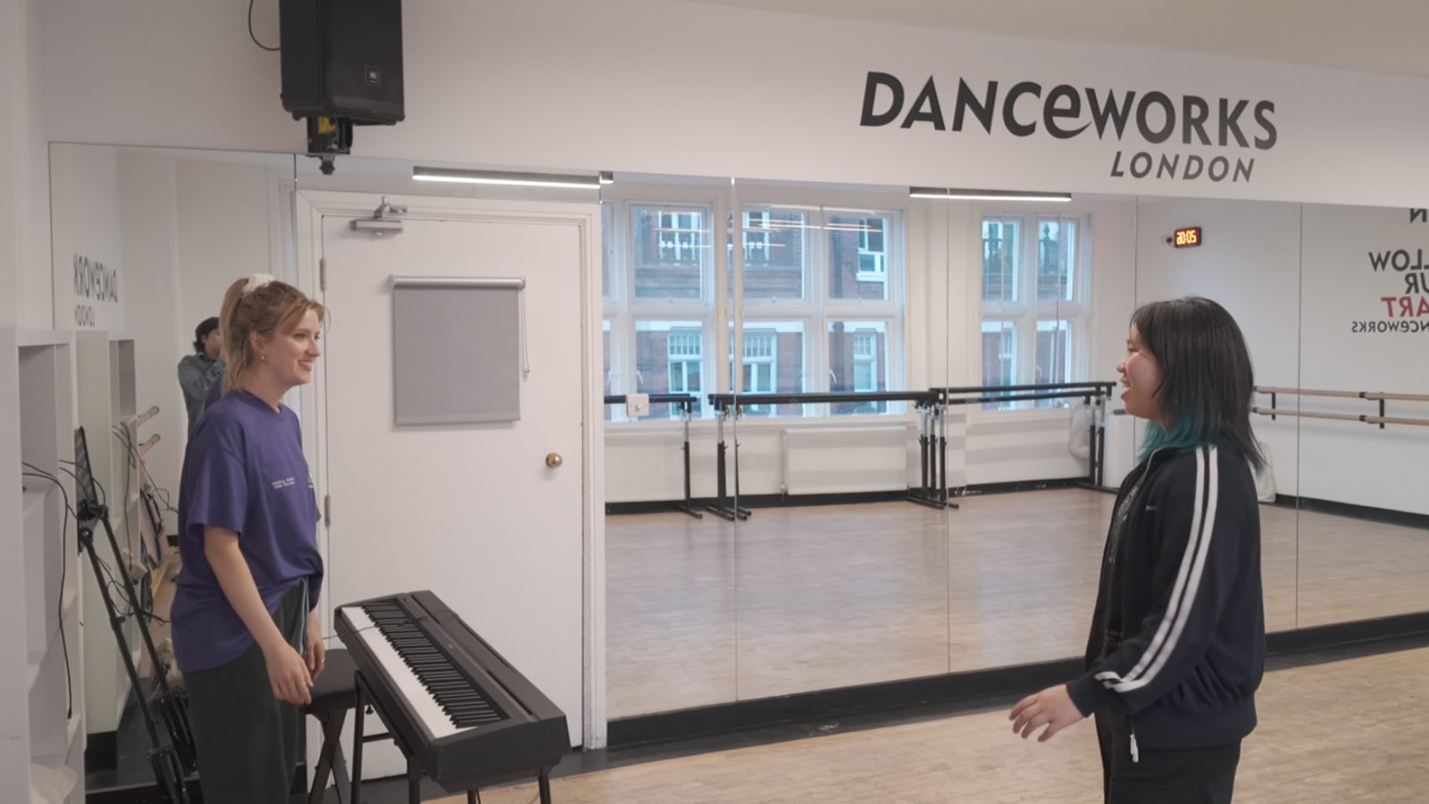 A student singing with a vocal coach at the piano