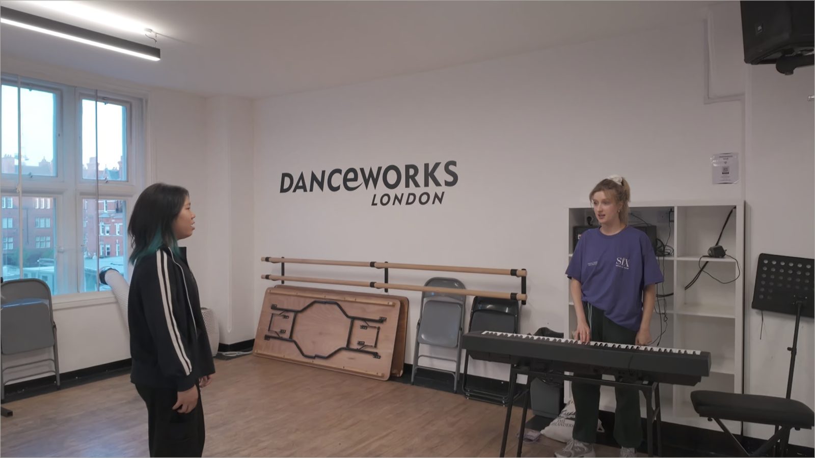 A student singing with a vocal coach at the keyboard